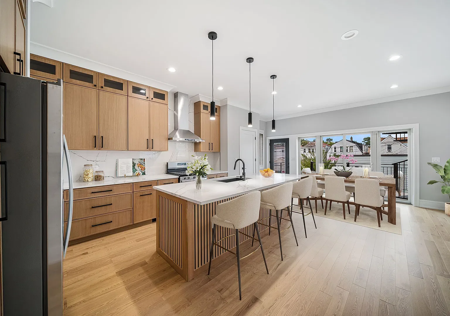 Light oak cabinetry and open-concept kitchen