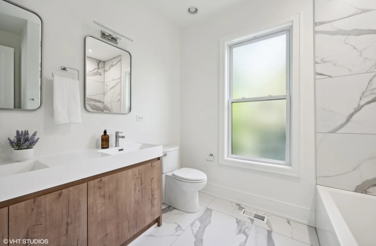 Bright modern bathroom with wood double vanity and tile